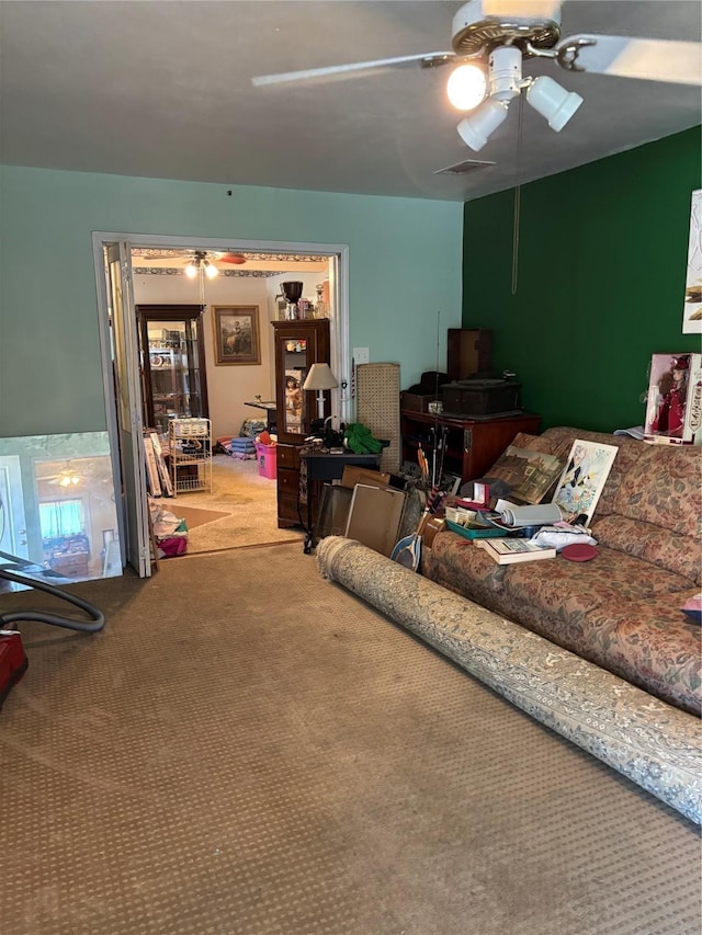 living room featuring carpet flooring and ceiling fan