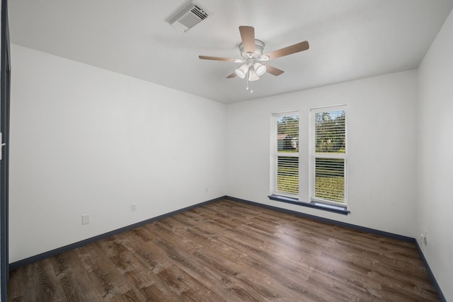 spare room with dark hardwood / wood-style floors