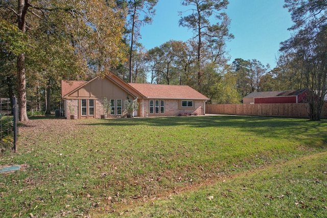 rear view of house featuring a lawn