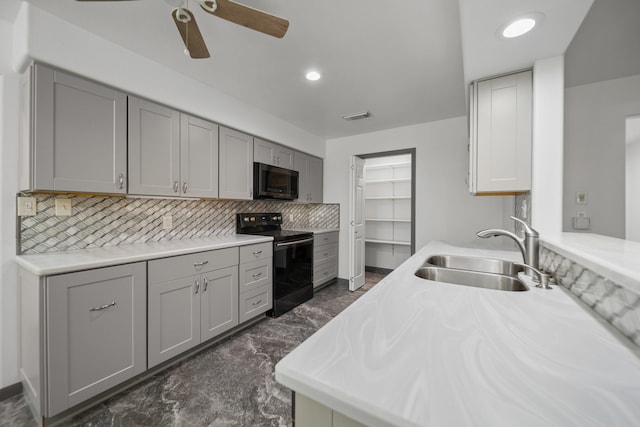 kitchen with gray cabinets, black electric range, and sink