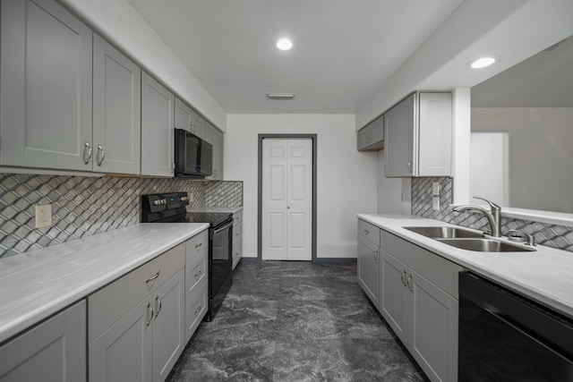 kitchen with backsplash, gray cabinetry, sink, and black appliances