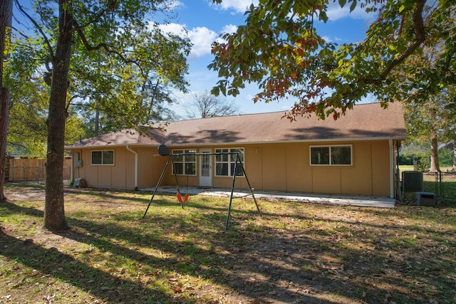 rear view of property featuring a yard