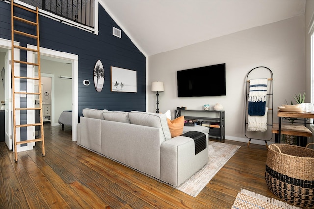 living room featuring high vaulted ceiling and dark wood-type flooring