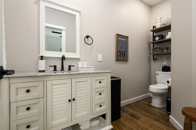 bathroom featuring vanity, toilet, and wood-type flooring