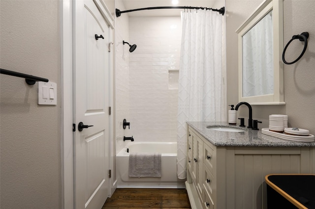 bathroom featuring hardwood / wood-style floors, shower / bath combo, and vanity