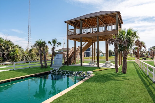 view of pool featuring a wooden deck and a yard