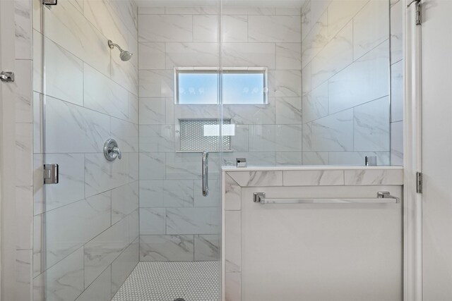 bathroom featuring a shower with shower door