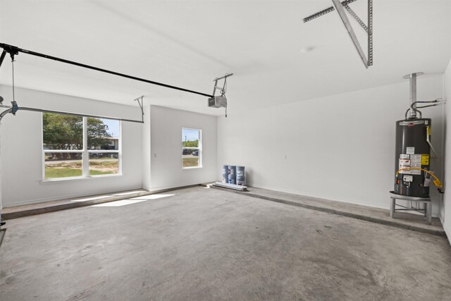 garage with a garage door opener and water heater