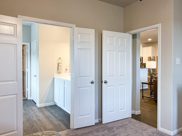 interior space featuring wood-type flooring and connected bathroom