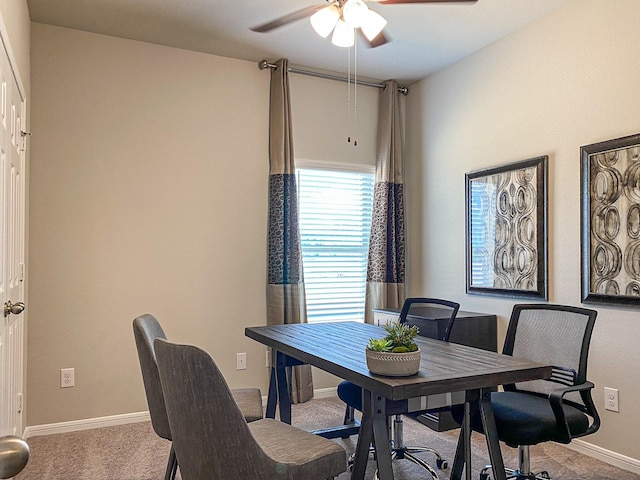 dining space featuring ceiling fan and light carpet