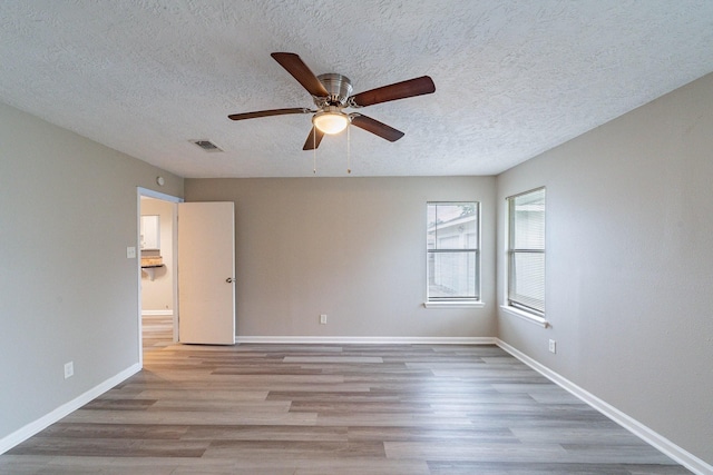 spare room featuring ceiling fan and light wood-type flooring