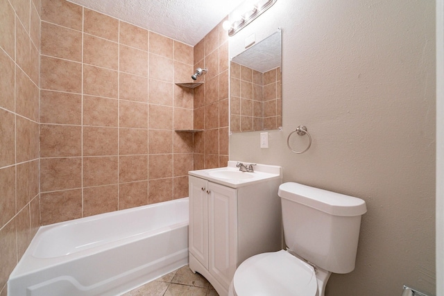 full bathroom with tile patterned floors, vanity, a textured ceiling, tiled shower / bath combo, and toilet