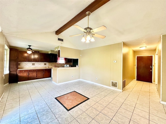 interior space with ceiling fan, lofted ceiling with beams, and light tile patterned flooring