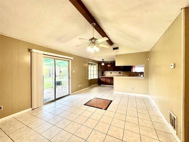 unfurnished living room featuring vaulted ceiling with beams, ceiling fan, and light tile patterned floors