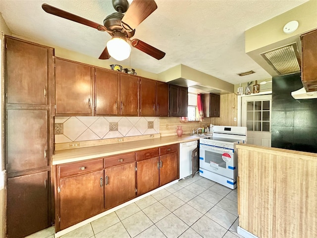 kitchen featuring tasteful backsplash, a textured ceiling, white appliances, ceiling fan, and light tile patterned flooring