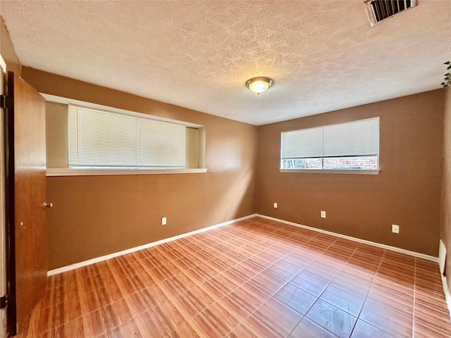 spare room featuring a textured ceiling