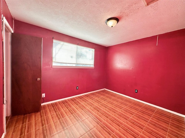 empty room with a textured ceiling