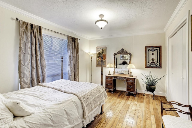 bedroom with wood-type flooring, a textured ceiling, and ornamental molding