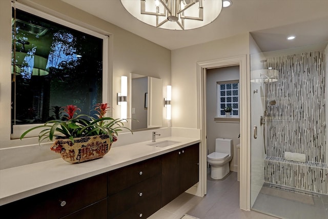 bathroom featuring walk in shower, vanity, a chandelier, tile patterned flooring, and toilet