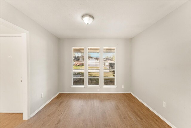 unfurnished room with light hardwood / wood-style flooring