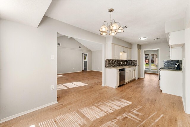 kitchen with backsplash, stainless steel dishwasher, light hardwood / wood-style floors, white cabinetry, and a chandelier