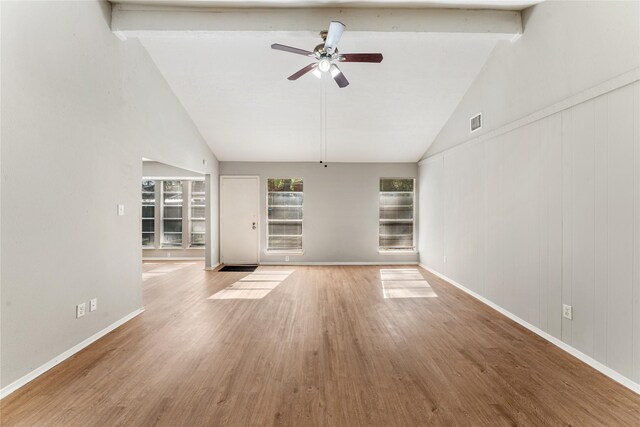 unfurnished living room featuring hardwood / wood-style flooring, ceiling fan, beam ceiling, and high vaulted ceiling