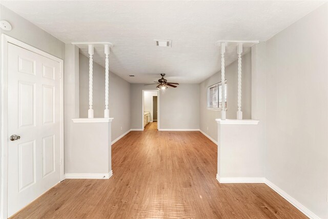 unfurnished living room with ceiling fan and light wood-type flooring