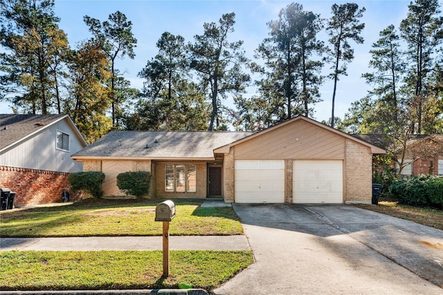 single story home with a garage and a front lawn