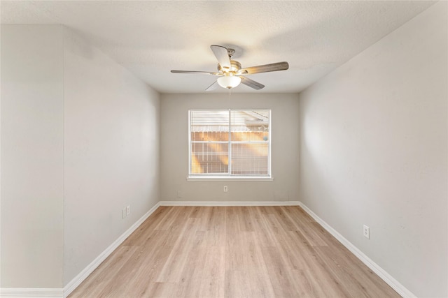 spare room featuring a textured ceiling, light hardwood / wood-style flooring, and ceiling fan