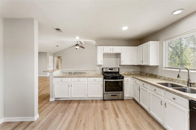 kitchen featuring white cabinetry, sink, stainless steel range with gas cooktop, light hardwood / wood-style flooring, and lofted ceiling