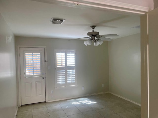 doorway to outside with ceiling fan and light tile patterned flooring