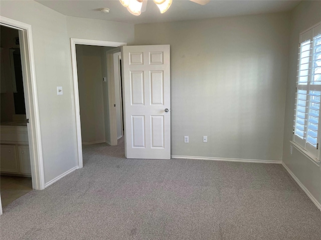 unfurnished bedroom featuring ceiling fan and light colored carpet