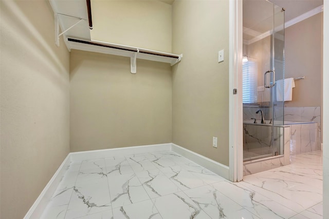 walk in closet featuring marble finish floor