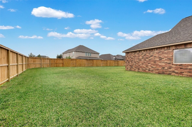 view of yard with a fenced backyard