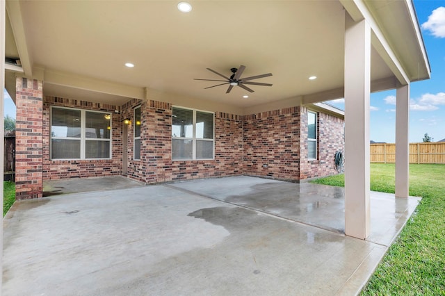 view of patio with ceiling fan and fence