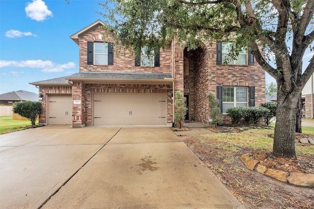 traditional home featuring a garage, concrete driveway, and brick siding