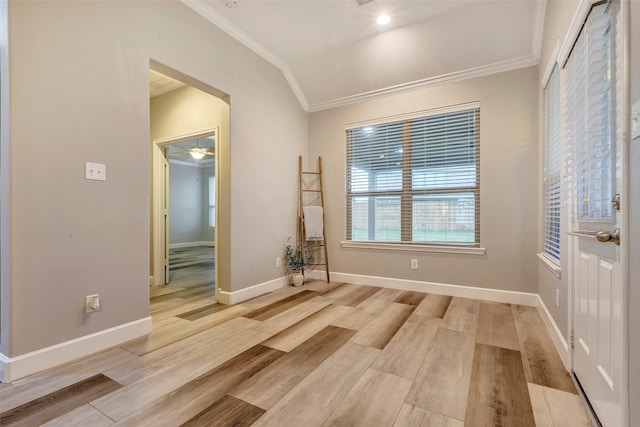 unfurnished room with arched walkways, ornamental molding, light wood-type flooring, and baseboards