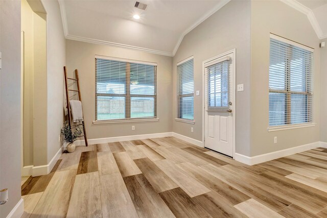 entryway featuring ornamental molding, lofted ceiling, visible vents, and light wood-style flooring