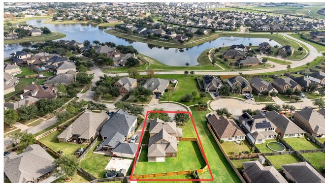 birds eye view of property featuring a water view and a residential view