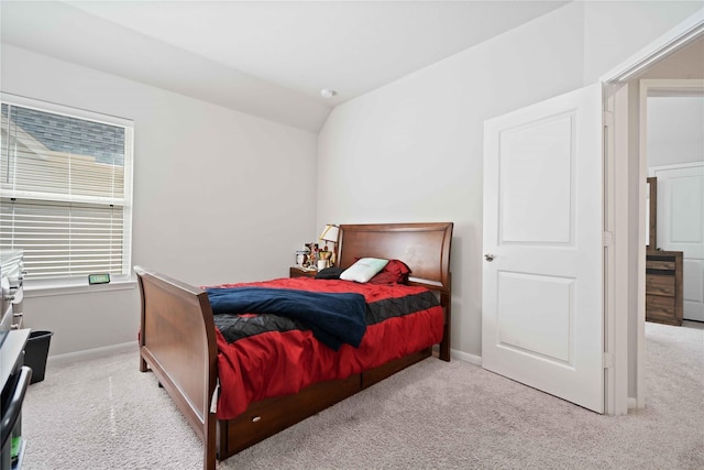 carpeted bedroom with vaulted ceiling