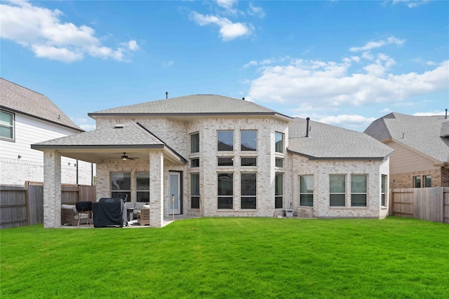 rear view of house featuring a lawn, a patio area, and ceiling fan