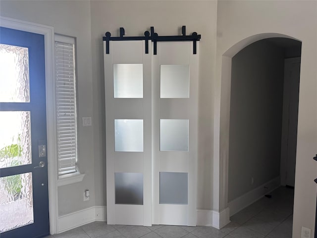 entrance foyer with light tile patterned floors and plenty of natural light