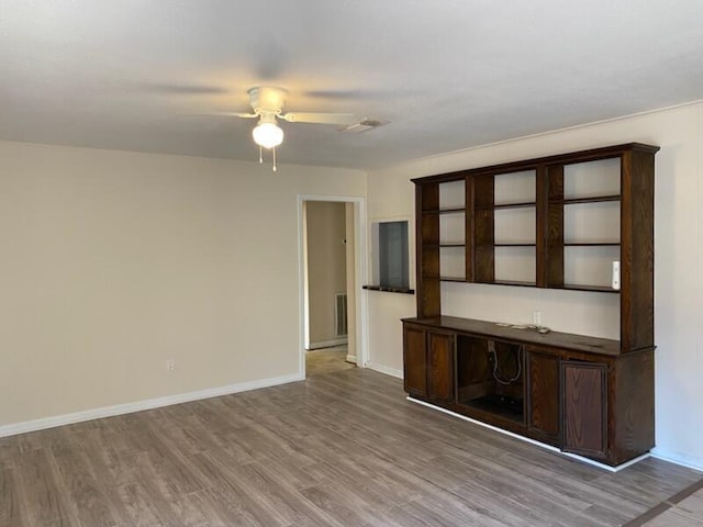 spare room with hardwood / wood-style floors and ceiling fan