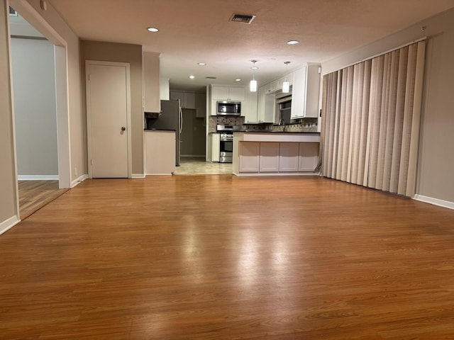 unfurnished living room with light hardwood / wood-style floors