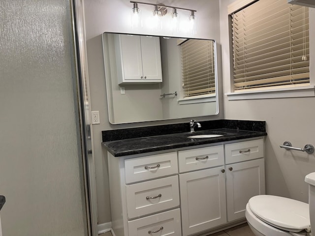 bathroom with tile patterned floors, toilet, and vanity