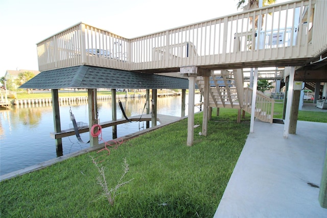 dock area featuring a lawn and a water view