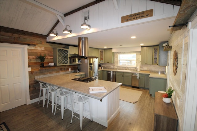 kitchen featuring appliances with stainless steel finishes, sink, green cabinetry, vaulted ceiling with beams, and wood walls