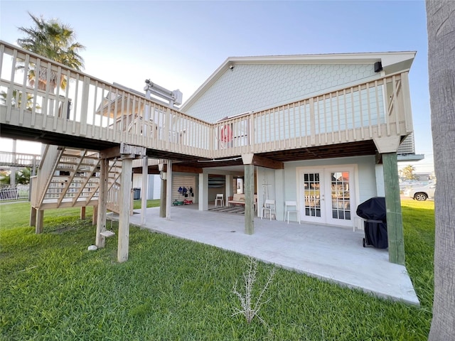 back of house with a yard, a deck, and a patio area