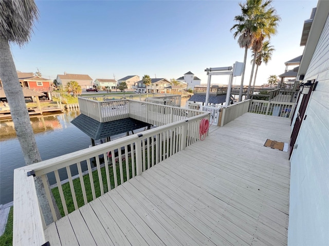 deck with a boat dock and a water view