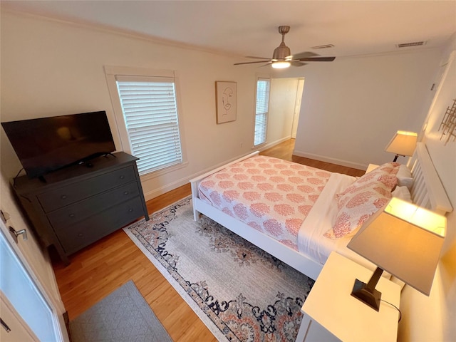 bedroom with light wood-type flooring and ceiling fan